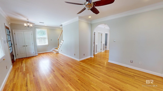 1651 Laurel St, Mobile, AL 36604 - unfurnished room featuring a chandelier, a ceiling fan, light wood finished floors, arched walkways, and baseboards