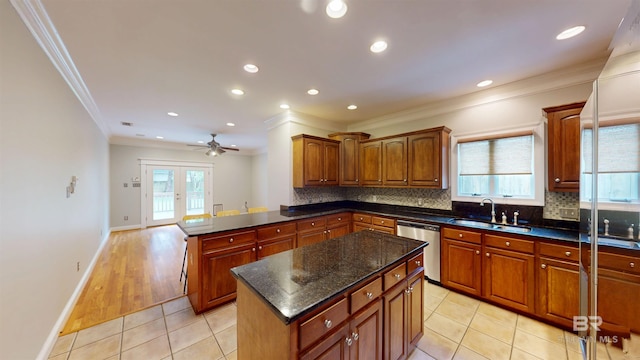 1651 Laurel St, Mobile, AL 36604 - kitchen featuring stainless steel dishwasher, a sink, ornamental molding, a ceiling fan, and a peninsula