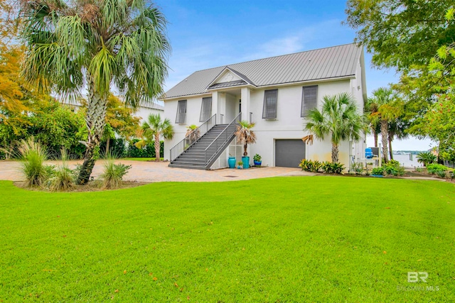 view of front of house with a garage and a front lawn