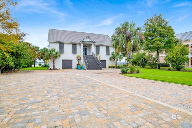 view of front of house with a garage and a front lawn