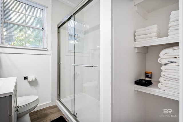 255 Pinehill Dr, Mobile, AL 36606 - bathroom with toilet, vanity, a shower stall, and wood finished floors