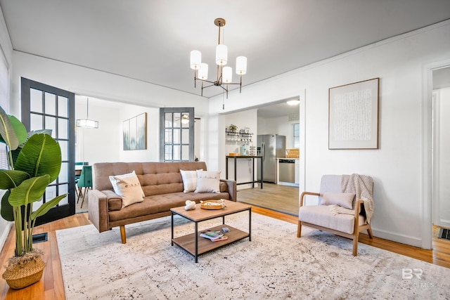 255 Pinehill Dr, Mobile, AL 36606 - living room with a chandelier, wood finished floors, and baseboards