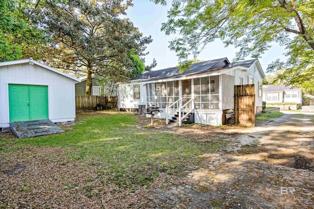 255 Pinehill Dr, Mobile, AL 36606 - back of property with a sunroom and an outdoor structure