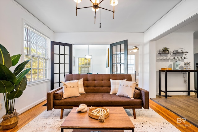255 Pinehill Dr, Mobile, AL 36606 - living area featuring healthy amount of natural light, wood finished floors, a chandelier, and baseboards