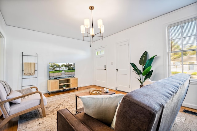255 Pinehill Dr, Mobile, AL 36606 - living room with a chandelier, wood finished floors, and baseboards