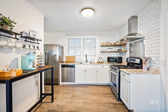 255 Pinehill Dr, Mobile, AL 36606 - kitchen with stainless steel appliances, exhaust hood, open shelves, a sink, and decorative backsplash