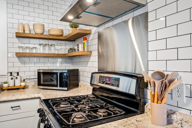 255 Pinehill Dr, Mobile, AL 36606 - kitchen featuring stainless steel appliances, decorative backsplash, open shelves, and ventilation hood