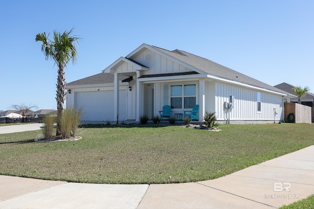 view of front of property featuring a garage, roof with shingles, board and batten siding, and a front yard