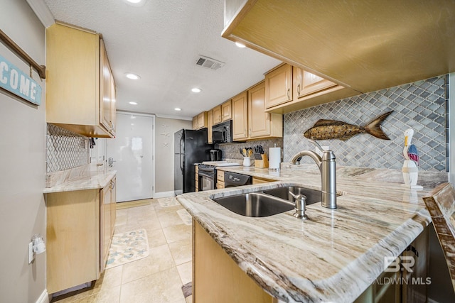 kitchen featuring decorative backsplash, light brown cabinetry, a textured ceiling, sink, and black appliances