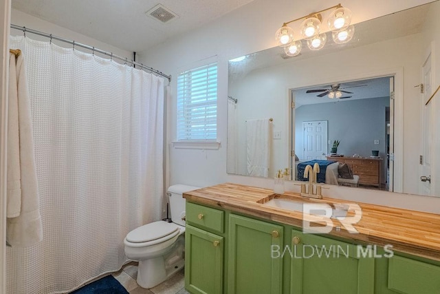 bathroom featuring ceiling fan, toilet, tile patterned floors, a shower with shower curtain, and vanity