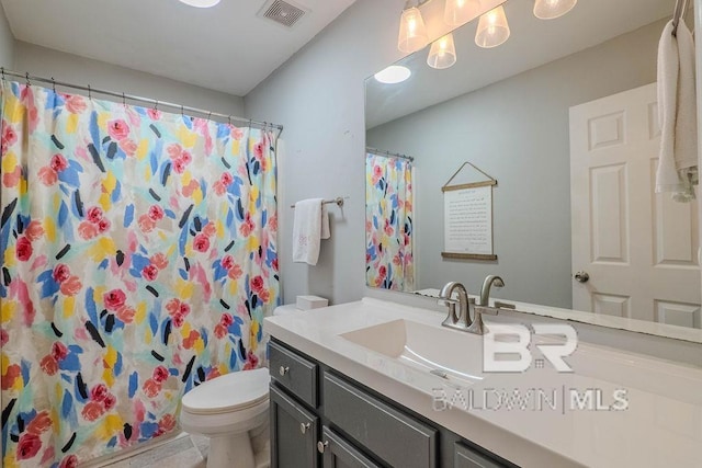 bathroom featuring vanity, tile patterned flooring, toilet, and curtained shower