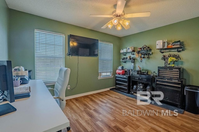 office area with hardwood / wood-style flooring, a textured ceiling, and ceiling fan