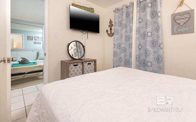 bedroom with light tile patterned flooring