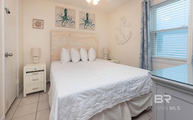 bedroom featuring light tile patterned flooring and multiple windows