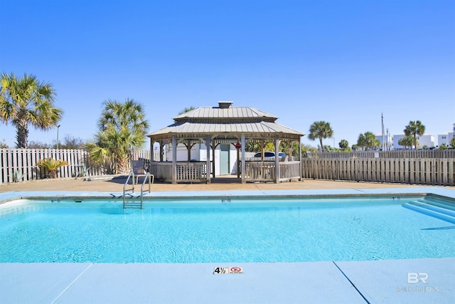 community pool featuring fence and a gazebo