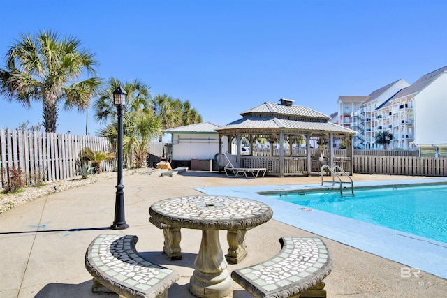 pool with a patio area, a fenced backyard, and a gazebo