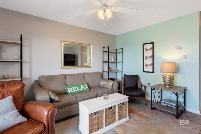 living room featuring a ceiling fan and baseboards