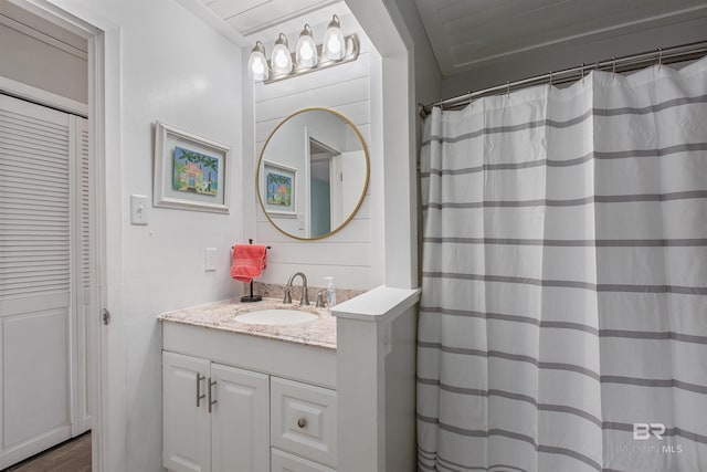 full bath with a shower with shower curtain and vanity