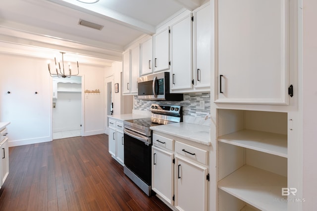 kitchen featuring dark hardwood / wood-style flooring, white cabinetry, appliances with stainless steel finishes, and pendant lighting