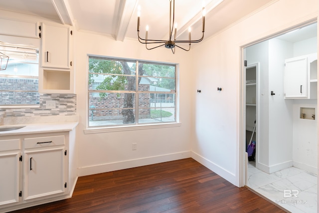 interior space featuring white cabinetry, decorative backsplash, beamed ceiling, and dark hardwood / wood-style floors