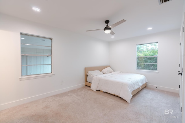 bedroom with light colored carpet and ceiling fan