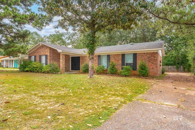 ranch-style home featuring a front yard