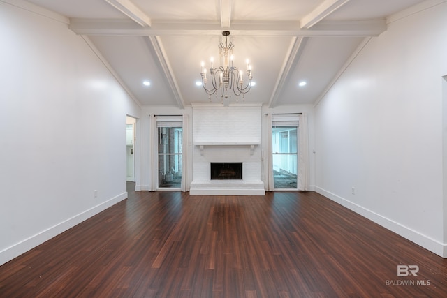 unfurnished living room featuring vaulted ceiling with beams, crown molding, a fireplace, dark hardwood / wood-style floors, and a chandelier