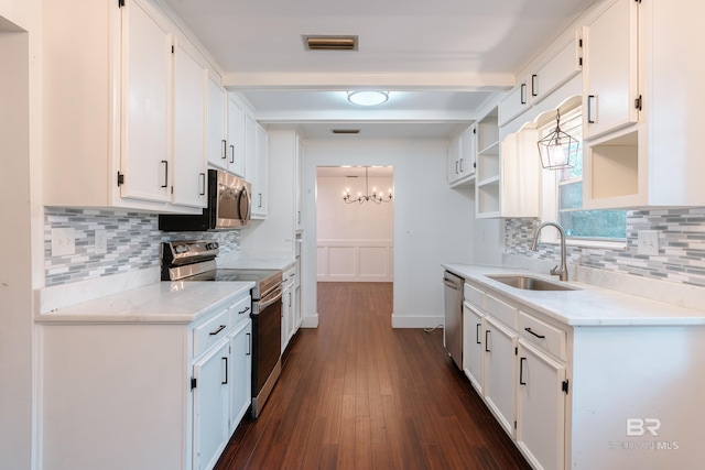 kitchen with white cabinets, stainless steel appliances, sink, and dark hardwood / wood-style floors