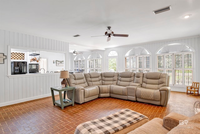 living room featuring a healthy amount of sunlight and ceiling fan