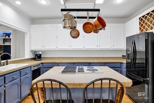 kitchen featuring light hardwood / wood-style flooring, blue cabinets, black appliances, and sink