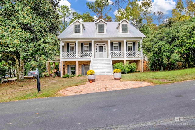 view of front of house featuring a front yard and a porch