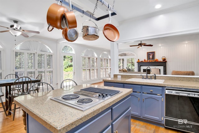 kitchen featuring sink, blue cabinetry, dishwasher, and plenty of natural light