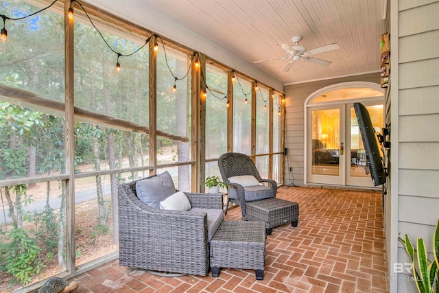 sunroom / solarium with ceiling fan and wood ceiling