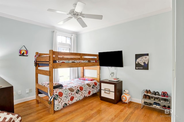 bedroom with crown molding, hardwood / wood-style flooring, and ceiling fan