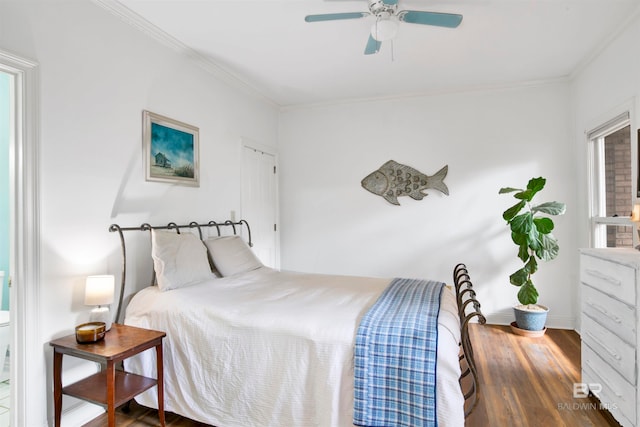 bedroom with ceiling fan, ornamental molding, and dark hardwood / wood-style flooring