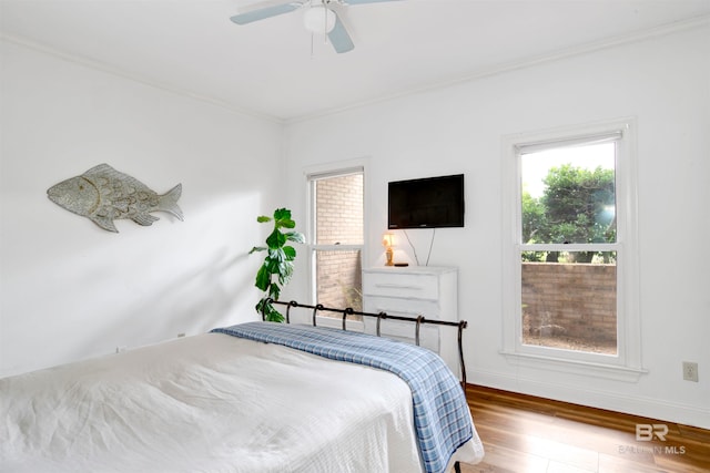 bedroom with ceiling fan, hardwood / wood-style flooring, and ornamental molding