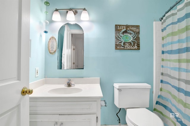 bathroom featuring vanity, a shower with curtain, and toilet