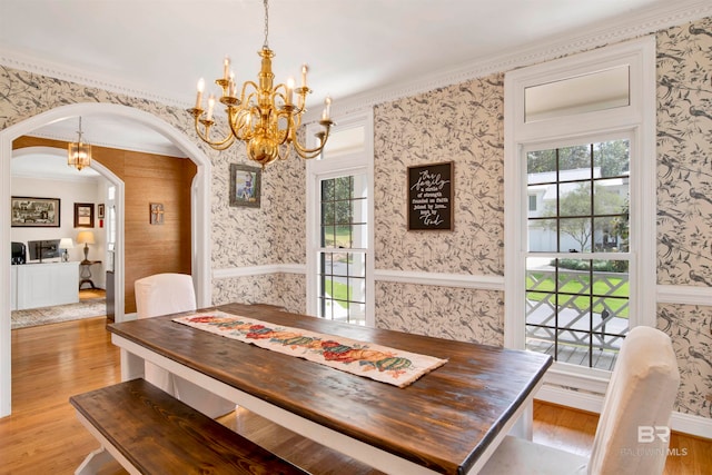 dining room featuring ornamental molding and light wood-type flooring