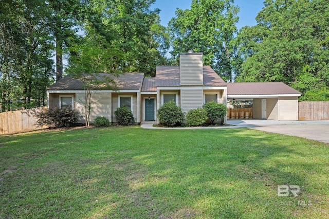 302 Norwood Ct, Bay Minette, AL 36507 - view of front of house featuring driveway, metal roof, a chimney, and a carport