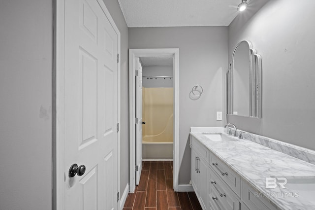 302 Norwood Ct, Bay Minette, AL 36507 - full bathroom with vanity, a textured ceiling, wood finish floors, and baseboards