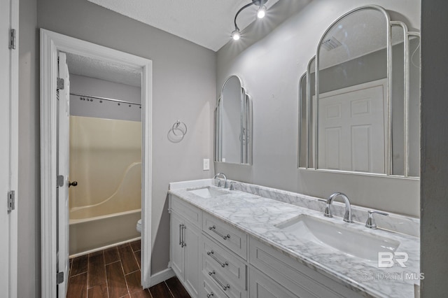 302 Norwood Ct, Bay Minette, AL 36507 - full bath featuring double vanity, toilet, shower / tub combination, wood tiled floors, and a textured ceiling