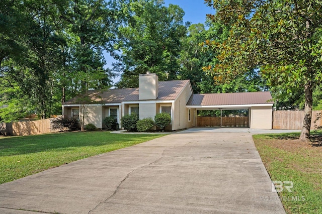 302 Norwood Ct, Bay Minette, AL 36507 - single story home featuring driveway, metal roof, a chimney, and an attached carport