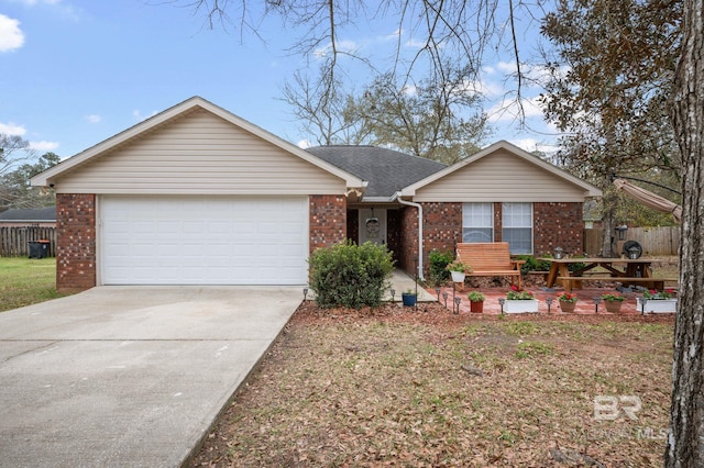 single story home with driveway, fence, an attached garage, a shingled roof, and brick siding