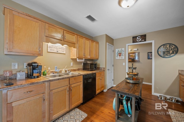 kitchen featuring stainless steel microwave, visible vents, black dishwasher, wood finished floors, and a sink