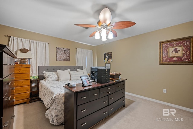 bedroom with light colored carpet, baseboards, and ceiling fan