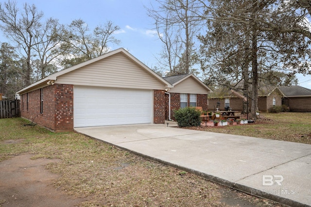 ranch-style home featuring concrete driveway, an attached garage, and brick siding