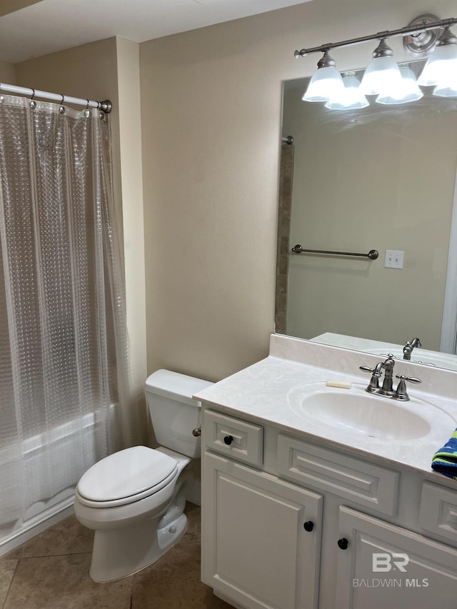 bathroom featuring toilet, vanity, and tile patterned floors