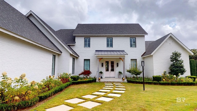 140 S Mcgregor Ave # E, Mobile, AL 36608 - view of front facade featuring brick siding, a front lawn, and roof with shingles