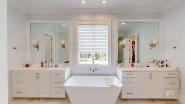 140 S Mcgregor Ave # E, Mobile, AL 36608 - full bathroom featuring a freestanding bath, two vanities, recessed lighting, and ornamental molding