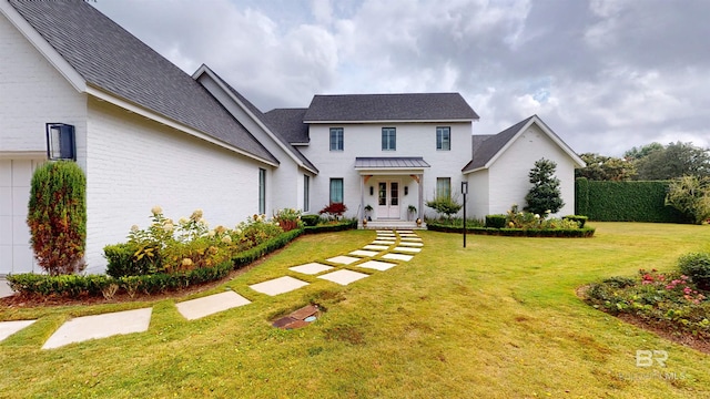 140 S Mcgregor Ave # E, Mobile, AL 36608 - view of front of home with a front lawn, roof with shingles, and brick siding